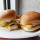 hand holding two types of sliders on plate